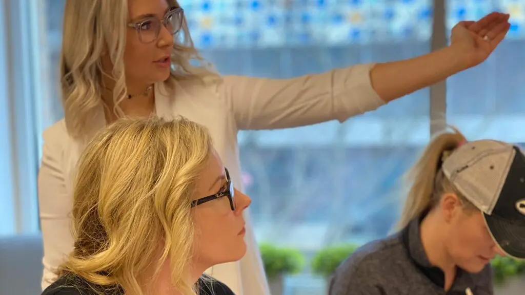 Instructor explaining a technique during a Beauty Angels Academy class