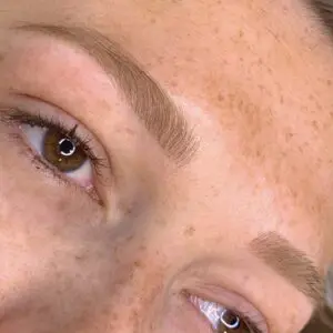Close-up of softly shaded permanent makeup brows on an Eastside client.